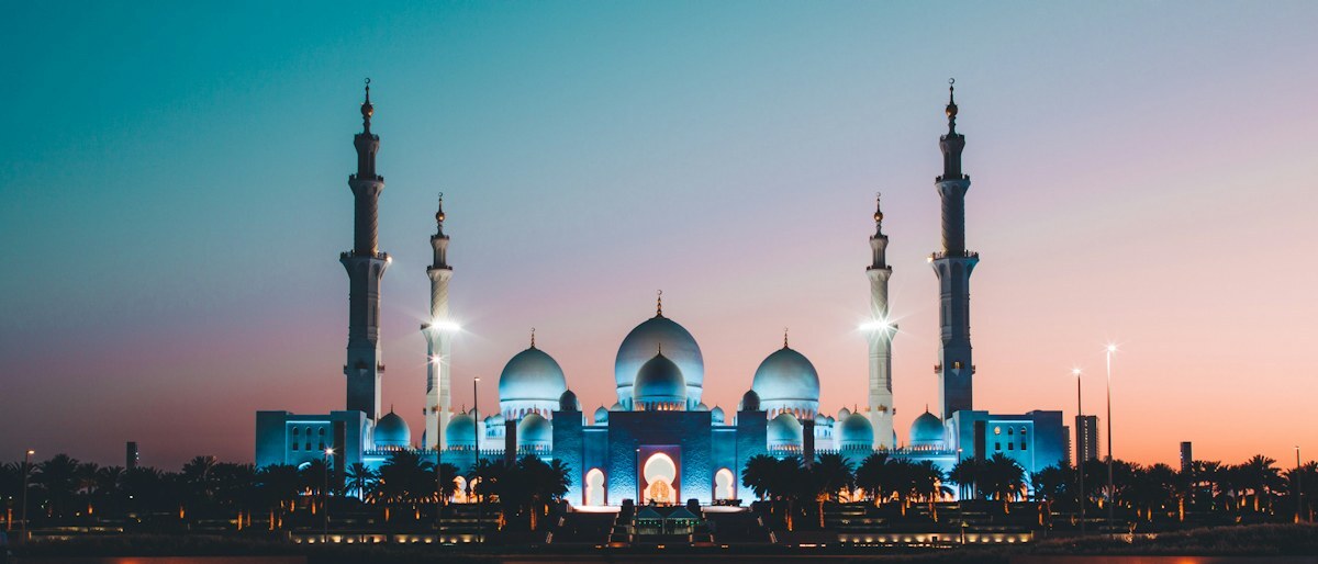 La Gran Mezquita Sheikh Zayed de Abu Dabi reflejada en el agua al anochecer